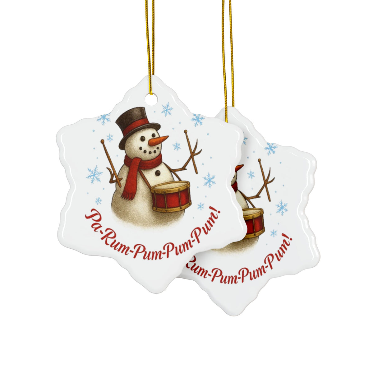 Two snowflake-shaped Christmas ornaments with a snowman and drum design on a white background.